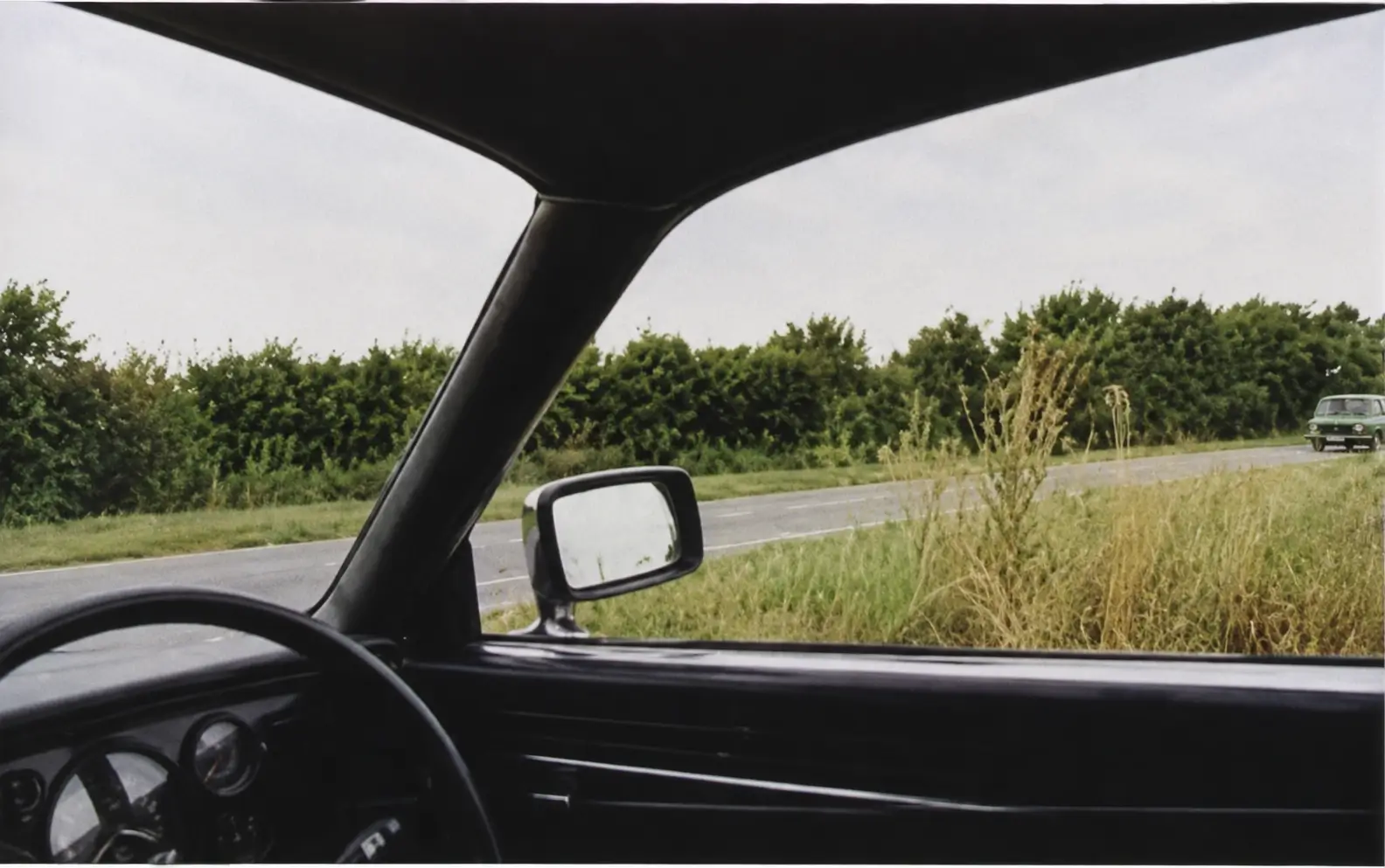 Driver's view from a farm track looking onto a main road
